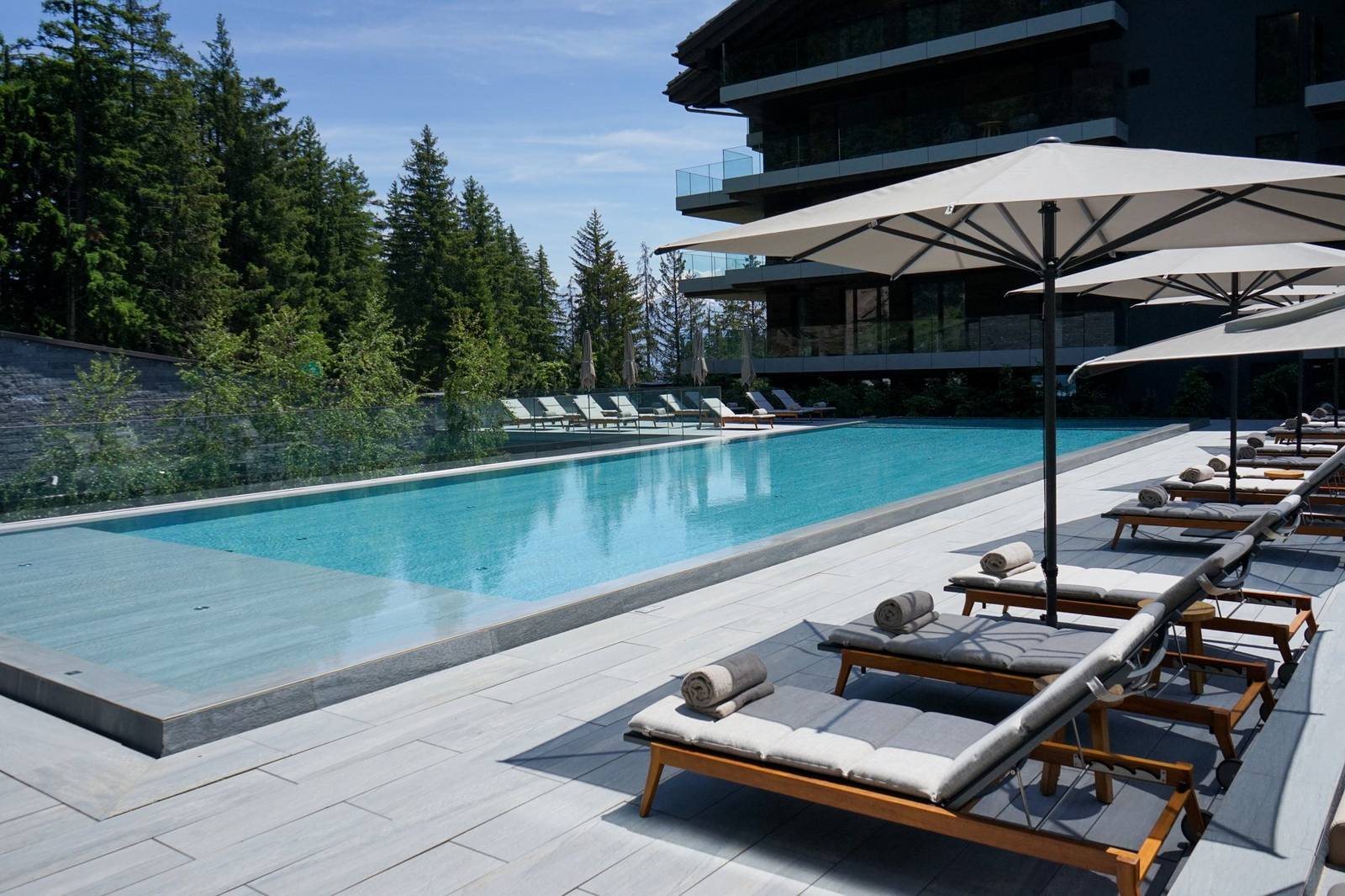 克蘭蒙塔納 Six Senses 屋頂泳池與森林環繞的酒店建築