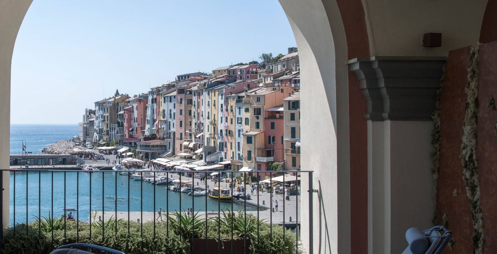 從 Grand Hotel Portovenere 迴廊拱門望見的彩色房屋與港灣