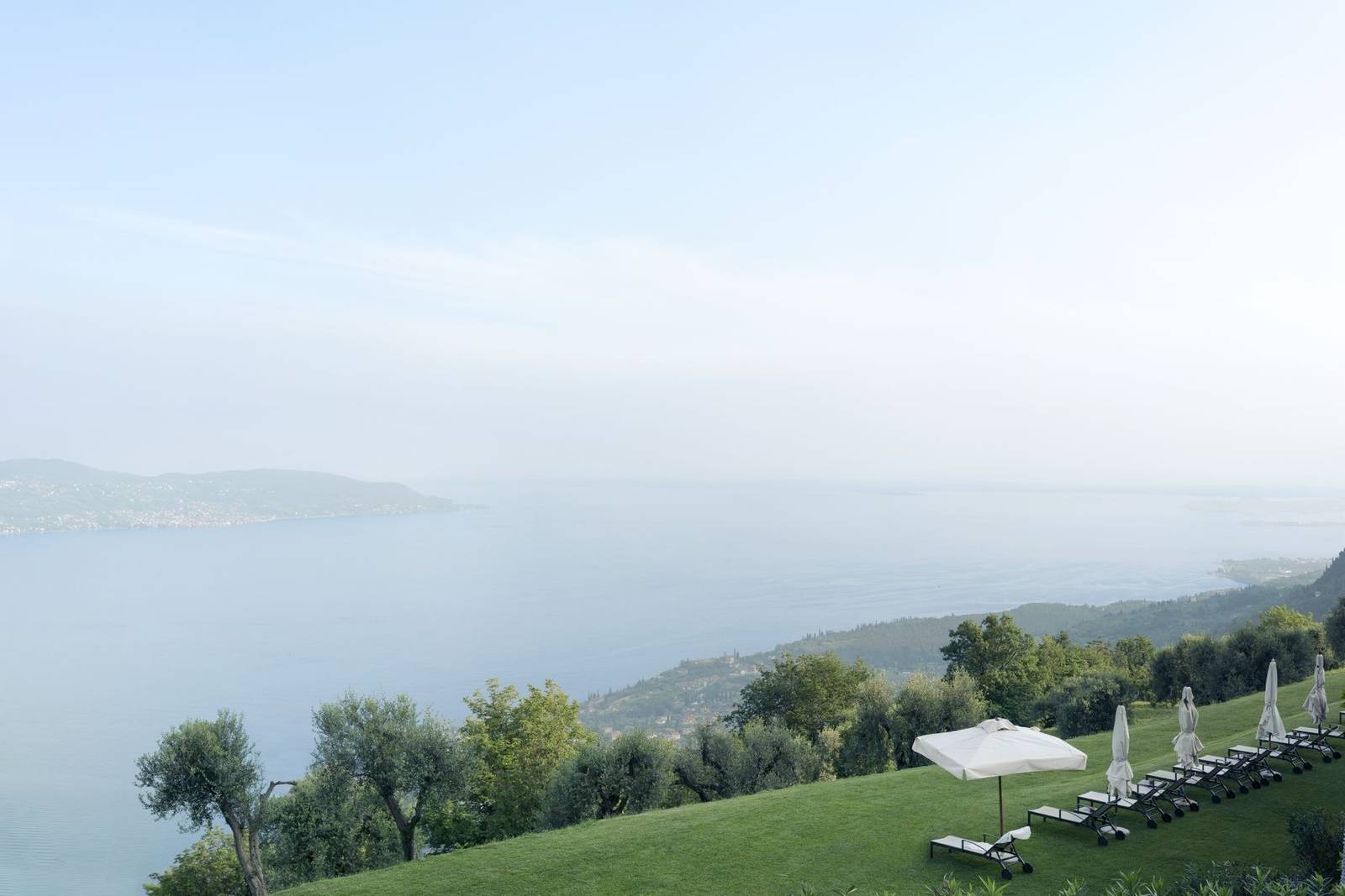 Lefay Resort & SPA 面向加爾達湖的草坪與遮陽傘